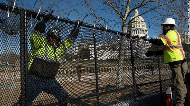 Razor wire is installed atop a security fence in preparation for next week&#39;s Presidential inauguration.