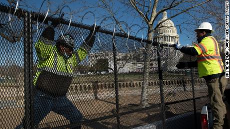 Razor wire is installed atop a security fence in preparation for next week&#39;s Presidential inauguration.