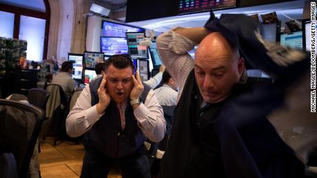 Traders work on the floor of the New York Stock Exchange on March 12, 2020. 