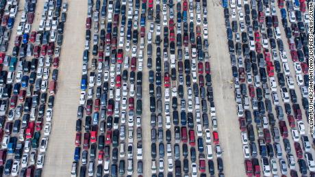 People wait in their cars for the San Antonio Food Bank to begin distributing food on April 9, 2020. 