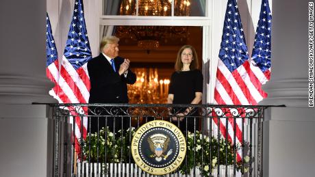 Trump applauds Judge Amy Coney Barrett after she was sworn in as a US Supreme Court Associate Justice.