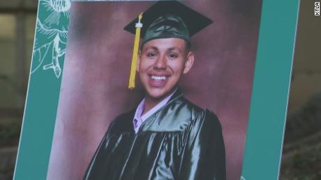 Andres Guardado wears a cap and gown in a photo displayed at a news conference held by his family in downtown Los Angeles on June 30, 2020.
