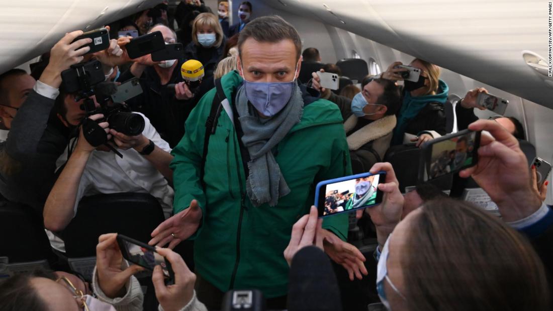 Alexey Navalny leaves Germany on a Russian plane five months after being poisoned