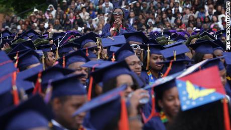 WASHINGTON, DC - MAY 07:  Ciearra Jefferson (C) of Detroit, Michigan, a member of the class of 2016, reacts as U.S. President Barack Obama mentions about her in his address for the 2016 commencement ceremony at Howard University May 7, 2016 in Washington, DC. President Obama is the sixth sitting U.S. president to deliver the commencement speech at Howard University.  (Photo by Alex Wong/Getty Images)