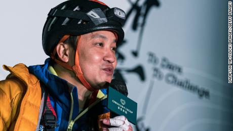 Lai Chi-wai talking to the press after climbing 250 meters (820 feet) up a skyscraper in Hong Kong on January 16. 