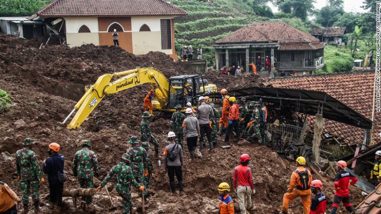 Rescue teams search for victims buried by the landslides in Cihanjuang Village, West Java. 