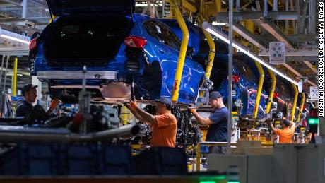 Workers fit Focus chassis inside the Ford factory in Saarlouis, Germany, in 2019.