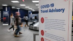 NEW YORK CITY - NOVEMBER 24: Signs warn travelers of Covid-19 in New York&#39;s LaGuardia Airport on November 24, 2020 in New York City. Despite warnings from the government and politicians not to travel for the Thanksgiving holiday due to the Covid-19 pandemic, millions of Americans have been flying and driving to meet friends and family for the holiday.  (Photo by Spencer Platt/Getty Images)