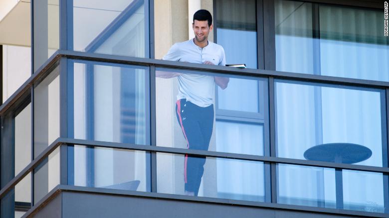 Serbia&#39;s Novak Djokovic stands on the balcony at his accommodation in Adelaide, Australia, on January 19, 2021. 