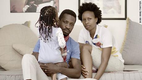 Bobi Wine and his wife, Barbara Itungo Kyagulanyi, pictured at home on January 19 during their ongoing house arrest, with his wife&#39;s 18-month-old niece who has since been removed from the house, Wine told CNN. 