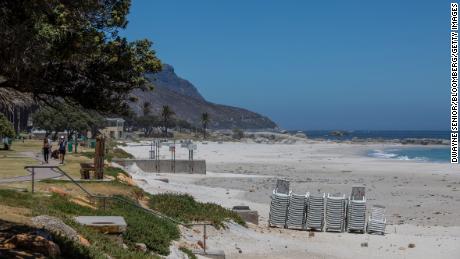 Stacked sunloungers on an empty Camps Bay beach, closed due to Covid-19 regulations, in Cape Town, South Africa, on Monday, Jan. 11, 2021. The pandemic and restrictions imposed to contain it have devastated Africa&#39;s most industrialized economy, and the extension of curbs that came into effect at the height of the holiday season bode ill for efforts to engineer a rebound. Photographer: Dwayne Senior/Bloomberg via Getty Images