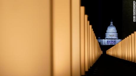 Lights surround the Lincoln Memorial Reflecting Pool, placed as a memorial to COVID-19 victims Tuesday, Jan. 19, 2021, in Washington, after President-elect Joe Biden spoke, with the U.S. Capitol in the background. (AP Photo/Alex Brandon)