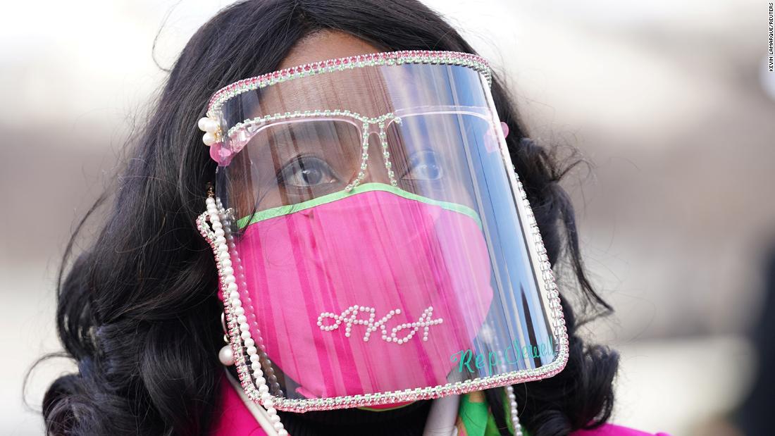 US Rep. Terri Sewell wears a face shield after arriving at the inauguration. Her mask references Alpha Kappa Alpha, Harris&#39; sorority.