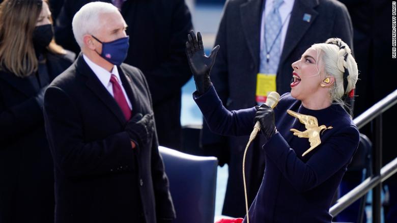 Lady Gaga sings the National Anthem as former Vice President Mike Pence looks on.
