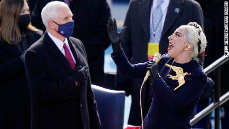 Lady Gaga sings the National Anthem as former Vice President Mike Pence looks on.