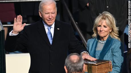 Joe Biden, flanked by incoming First Lady Jill Biden, is sworn in as the 46th US President on January 20, 2021, at the US Capitol in Washington, DC. (Photo by Saul Loeb via Getty Images)