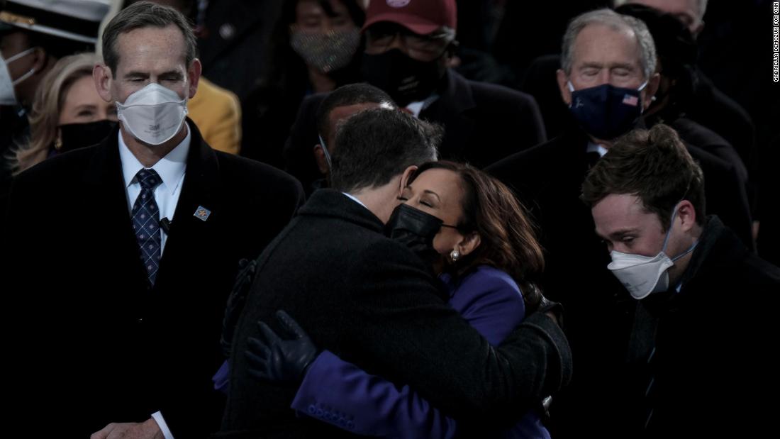 Harris hugs her husband before being sworn in as vice president.