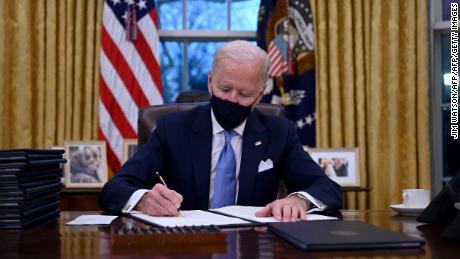 Biden unveils Covid-19 plan based on &#39;science not politics&#39; as he signs new initiatives 