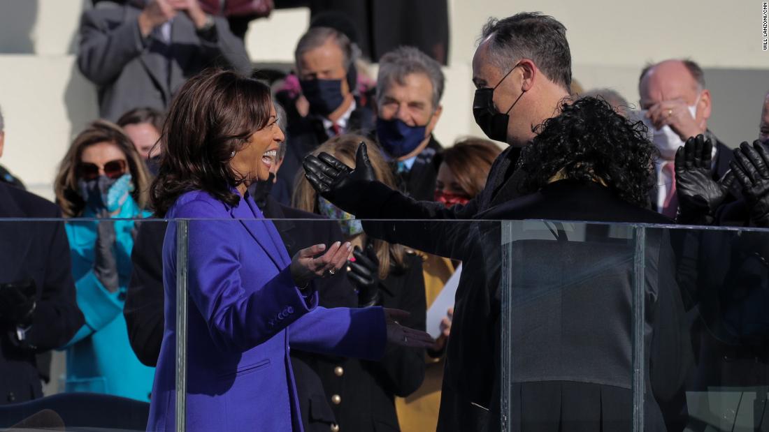 Harris smiles at her husband during her swearing-in.