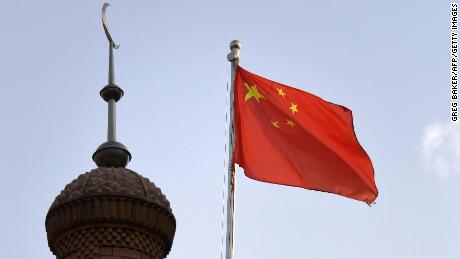The Chinese flag flies over the Juma mosque in the restored old city area of Kashgar, in China&#39;s western Xinjiang region, on June 4, 2019.