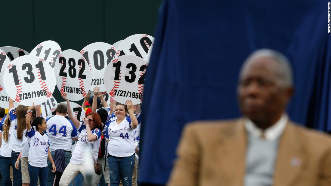 Atlanta fans hold up signs in 2014 that show every home run Aaron hit. He was being honored on the 40th anniversary of his 715th home run.