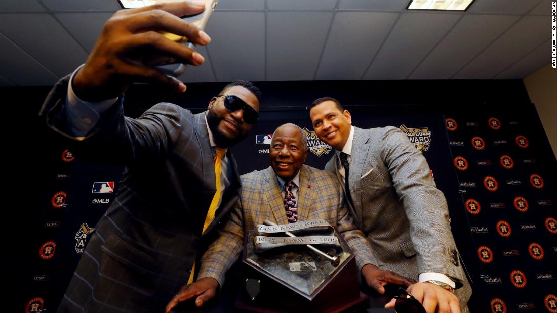 Aaron poses with former players David Ortiz, left, and Alex Rodriguez in 2019.