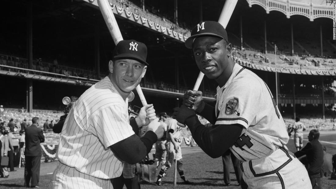 Aaron poses with New York Yankees slugger Mickey Mantle in 1957. That season, Aaron was named the National League&#39;s Most Valuable Player and his team defeated the Yankees to win the World Series. 
