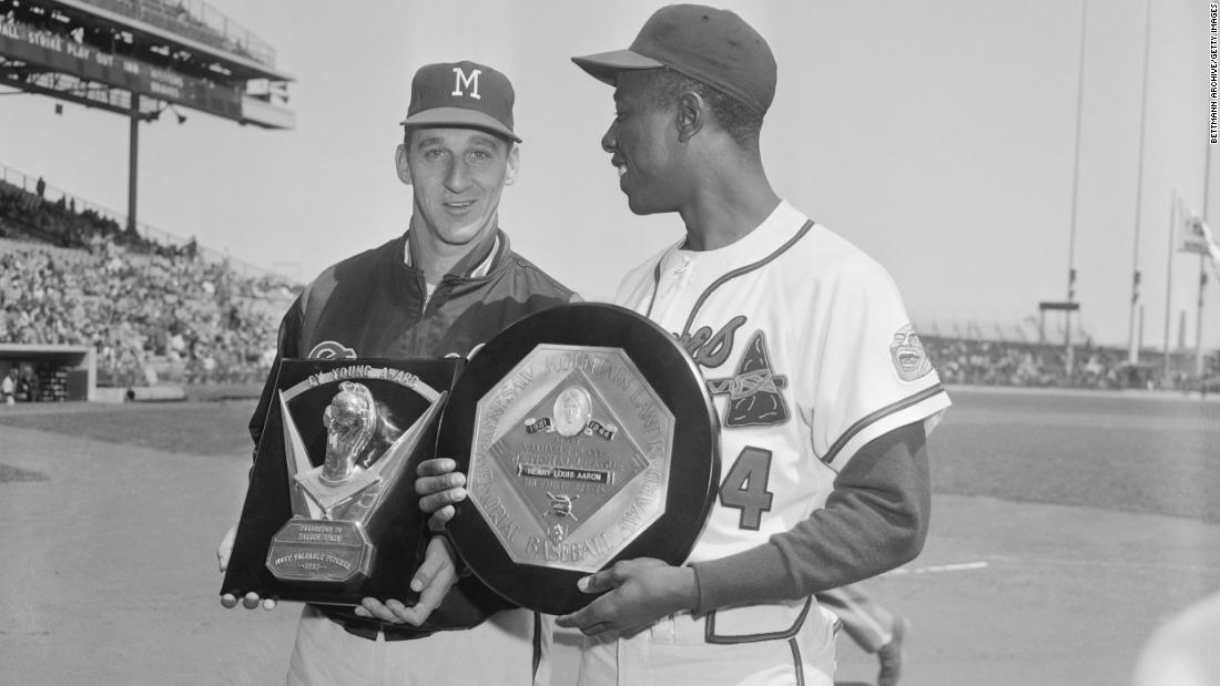 Aaron holds his MVP award with Braves pitcher Warren Spahn, who won the Cy Young Award that year.