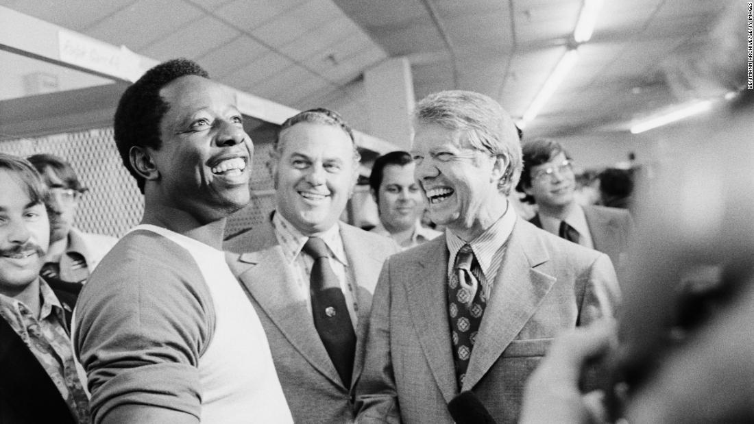 Future US President Jimmy Carter, then the governor of Georgia, laughs with Aaron during a clubhouse visit in 1973.