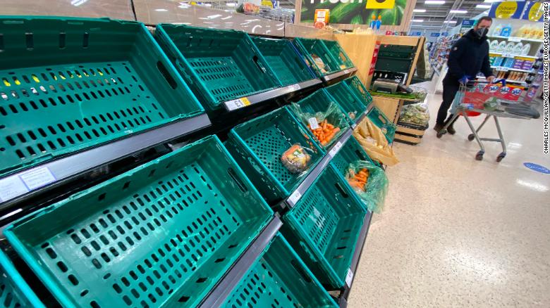 A supermarket customer looks at the near empty shelves in Tescos on January 14, 2021 in Belfast, Northern Ireland.