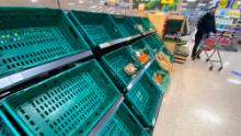 A supermarket customer looks at  near empty shelves in a supermarket in Belfast, Northern Ireland earlier this month.