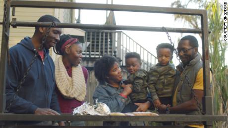 Barbecue historian Dr. Howard Conyers (left) cooks with his family in New Orleans on Jan.3, 2021.