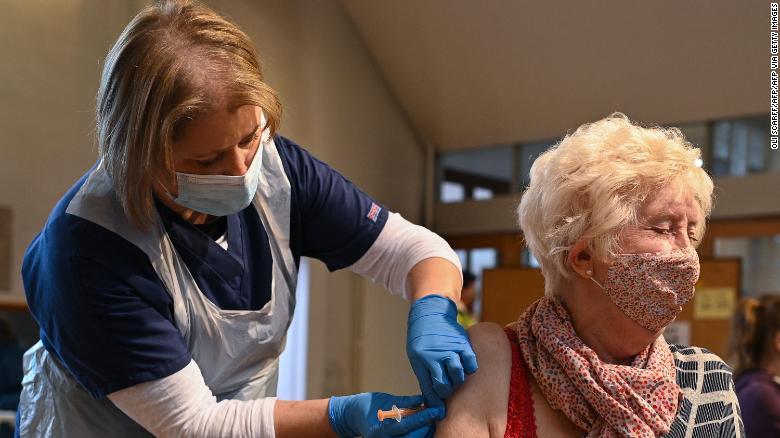 A woman from the top four priority groups receives the Oxford/AstraZeneca vaccine at a church in Yorkshire, northern England on January 23. 