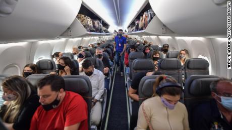 Passengers take their seats before take off in a Boeing 737 MAX aircraft operated by low-cost airline Gol at Guarulhos International Airport, near Sao Paulo on December 9, 2020, as the 737 MAX returns into use more than 20 months after it was grounded following two deadly crashes. (Photo by NELSON ALMEIDA / AFP) (Photo by NELSON ALMEIDA/AFP via Getty Images)
