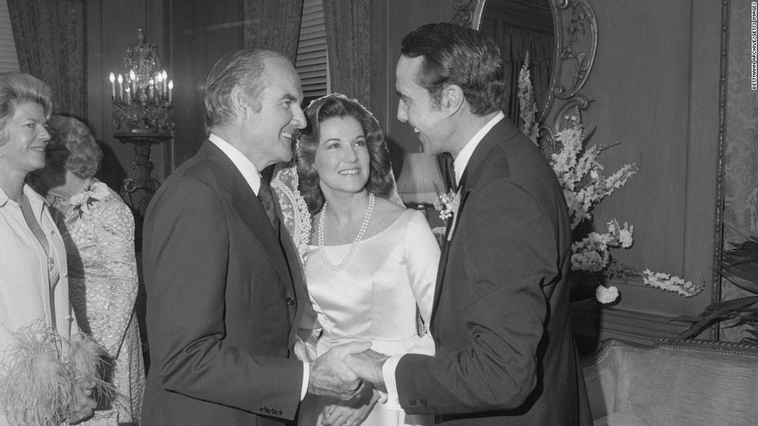 Dole, right, is congratulated by US Sen. George McGovern after his wedding in 1975. Dole&#39;s wife, Elizabeth, is seen at center.