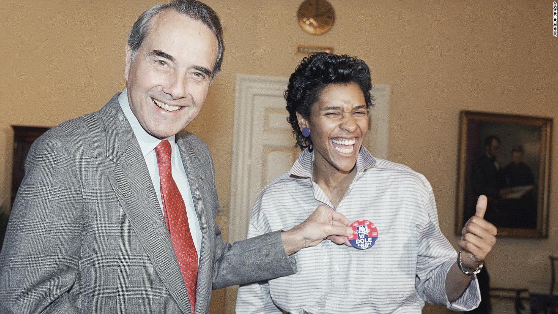 Dole ran for president again in 1988. Here, he holds a campaign button in front of Lynette Woodard of the Harlem Globetrotters.