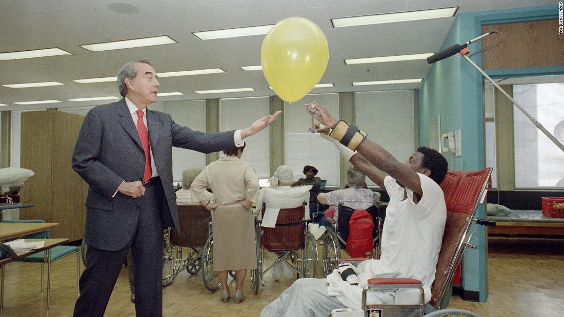 Dole tosses a balloon for Clarence Fondren to hit back during a campaign stop at the Chicago Rehabilitation Institute in 1988.