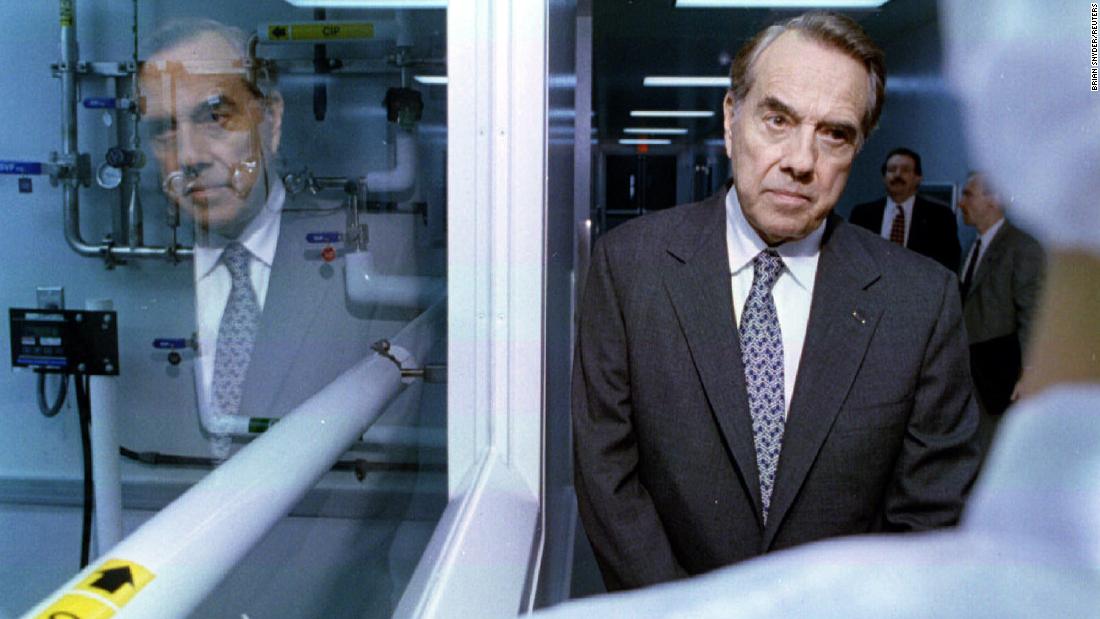 Dole listens to a technician during a campaign stop at a pharmaceutical company in Portsmouth, New Hampshire, in 1996.