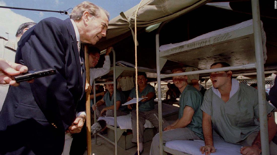 Dole talks with a prisoner at the Durango Jail&#39;s &quot;Tent City&#39;&#39; during a campaign visit in Phoenix in 1996. The outdoor jail, which housed approximately 1,200 male and 200 female prisoners at the time, was the site of Dole&#39;s speech about crime issues.