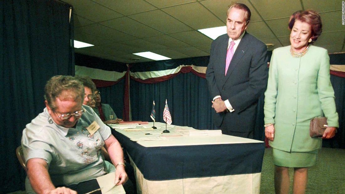 Dole and his wife, Elizabeth, watch election judge Fara Popp place their ballots into the ballot box in Russell, Kansas, in 1996.