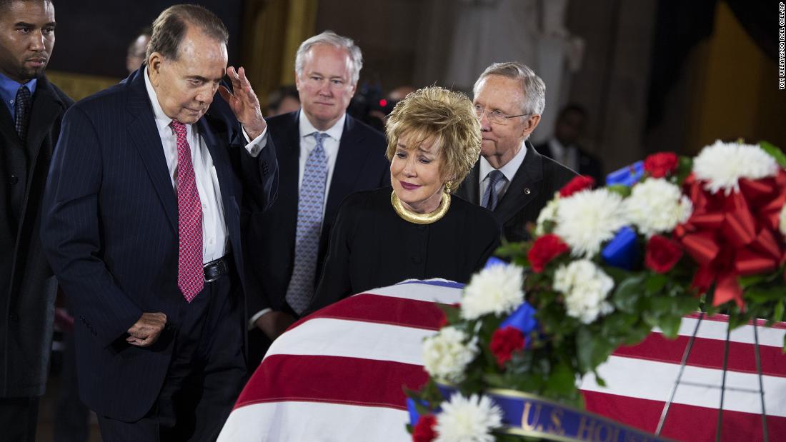 Dole salutes the casket of US Sen. Daniel Inouye as his body lies in state in the US Capitol rotunda in 2012. Dole and Inouye knew each other since they were recovering from their World War II battle wounds.