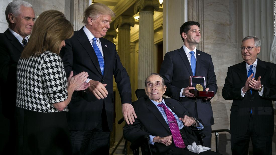 President Donald Trump greets Dole as House Speaker Paul Ryan holds Dole&#39;s Congressional Gold Medal in 2018. Trump honored Dole, calling the longtime Kansas lawmaker &quot;a true American hero.&quot;