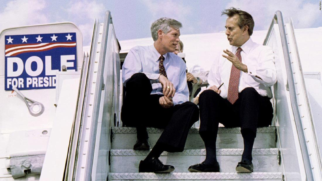 Dole speaks with US Sen. Connie Mack on the steps of an airplane following a campaign appearance in West Palm Beach, Florida, in 1996.