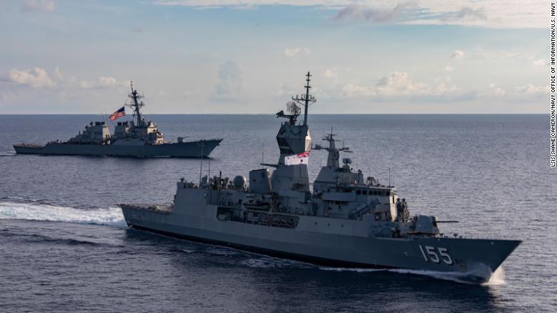 The guided-missile destroyer USS John S. McCain, rear, and the Royal Australian Navy frigate HMAS Ballarat sail together during integrated operations in the South China Sea in October 2020.