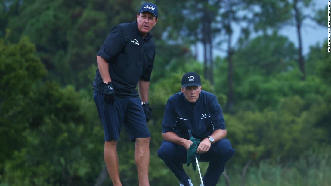 Pro golfer Phil Mickelson reads a putt for Brady as they team up for a made-for-TV charity match in May 2020. Mickelson and Brady lost a close match to Tiger Woods and Peyton Manning.