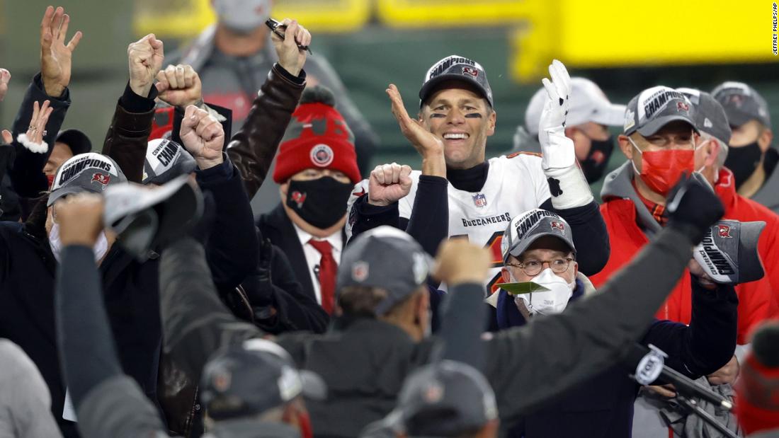Brady celebrates with his teammates in January 2021 after Tampa Bay defeated Green Bay to win the NFC and clinch a spot in the Super Bowl.