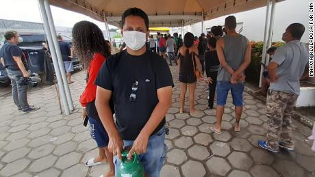 Joséni Costa Vicente queues to buy oxygen for her mother, Raxel, 69, in Manaus