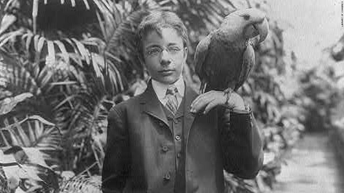 President Theodore Roosevelt&#39;s eldest son, Teddy Jr., holds a macaw named Eli circa 1902. The Roosevelts had all kind of animals, including lizards, snakes and a one-legged chicken.