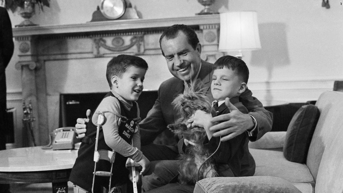 Richard Nixon shows off Pasha, his Yorkshire terrier, to two young visitors in 1969. Nixon also had two other dogs while in office.