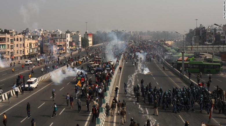 Police use tear gas to disperse farmers who marched to the capital during India&#39;s Republic Day celebrations in New Delhi, on January 26, 2021. 